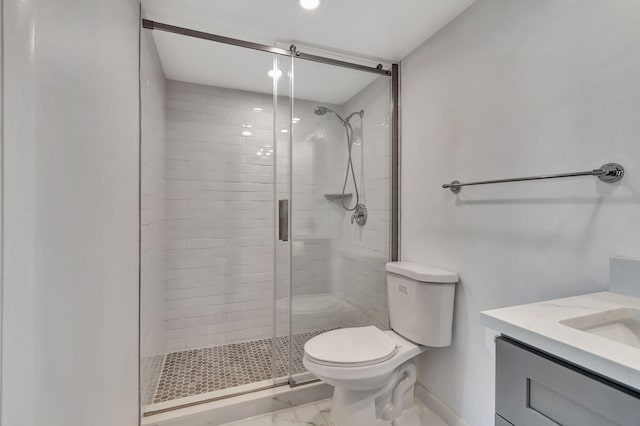 bathroom featuring toilet, vanity, and walk in shower