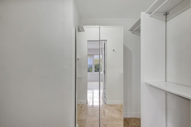 spacious closet with light tile patterned floors