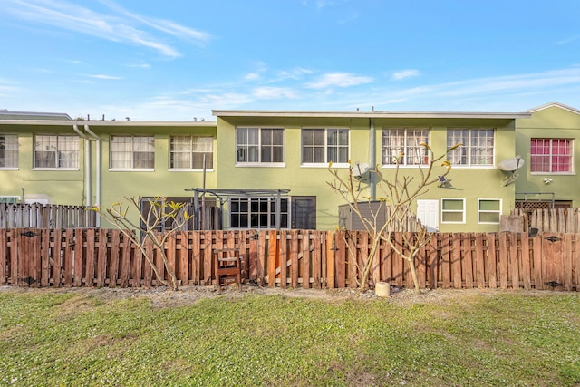 rear view of property featuring a yard