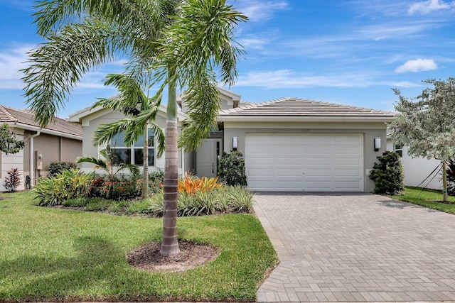 view of front facade with a garage and a front lawn