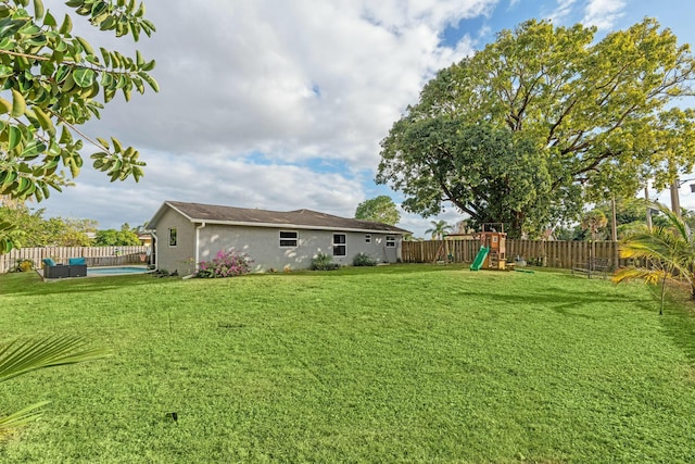 view of yard featuring an outdoor living space and a playground