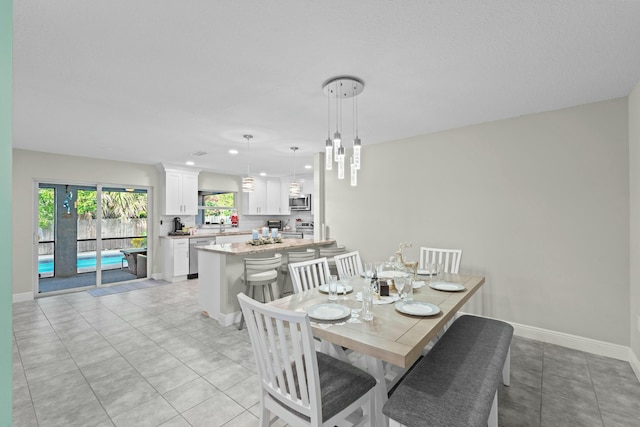 dining space featuring light tile patterned flooring