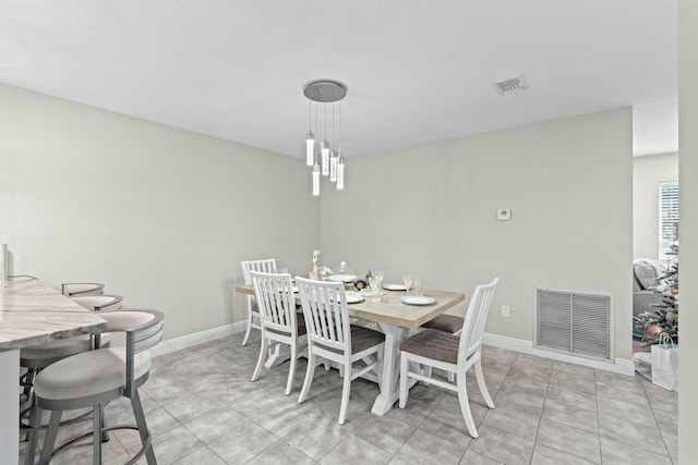 dining space featuring light tile patterned floors