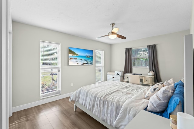 bedroom featuring ceiling fan, a textured ceiling, and hardwood / wood-style flooring