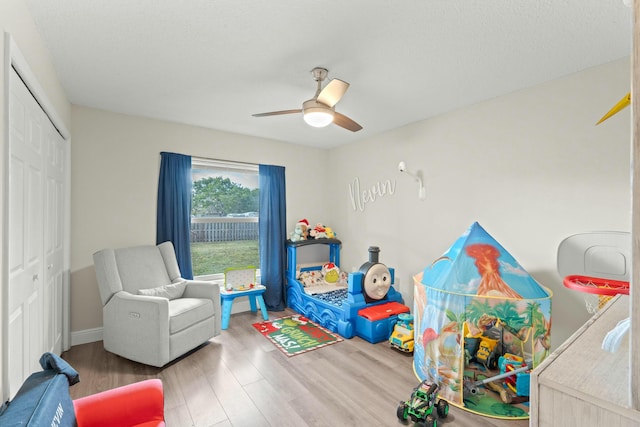 playroom with hardwood / wood-style flooring and ceiling fan