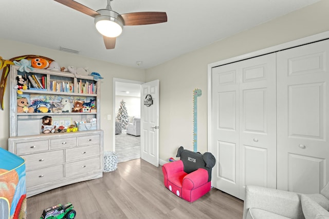 playroom featuring ceiling fan and light hardwood / wood-style floors