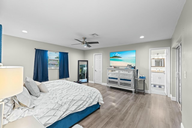 bedroom featuring connected bathroom, ceiling fan, and wood-type flooring