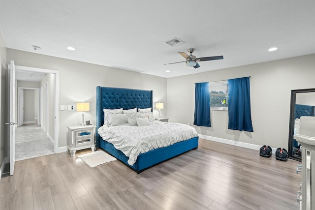 bedroom with ceiling fan and light hardwood / wood-style flooring