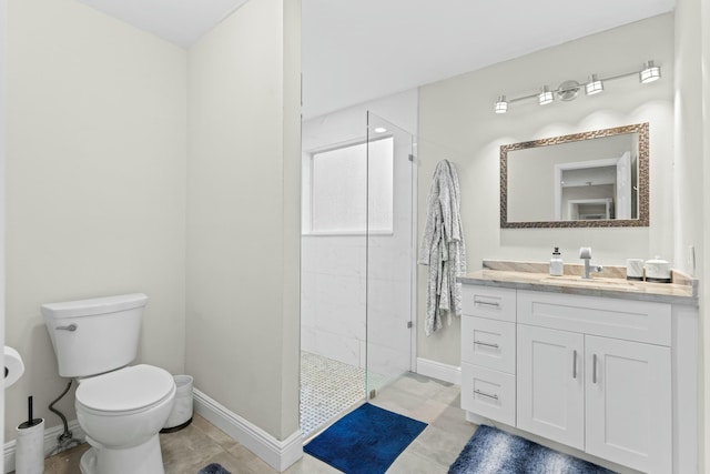 bathroom featuring tiled shower, vanity, and toilet