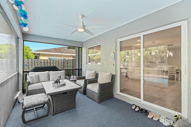 sunroom / solarium featuring ceiling fan