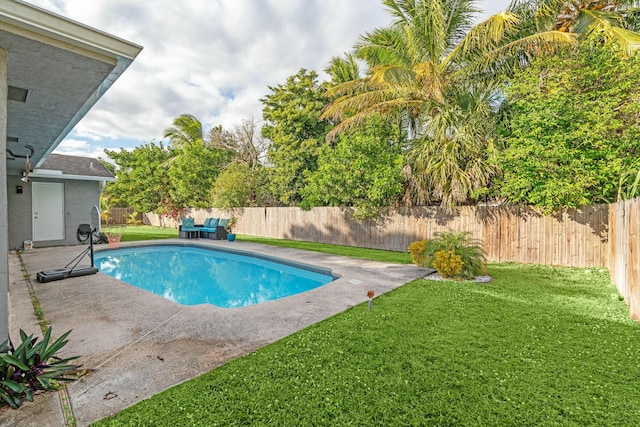 view of pool with a lawn