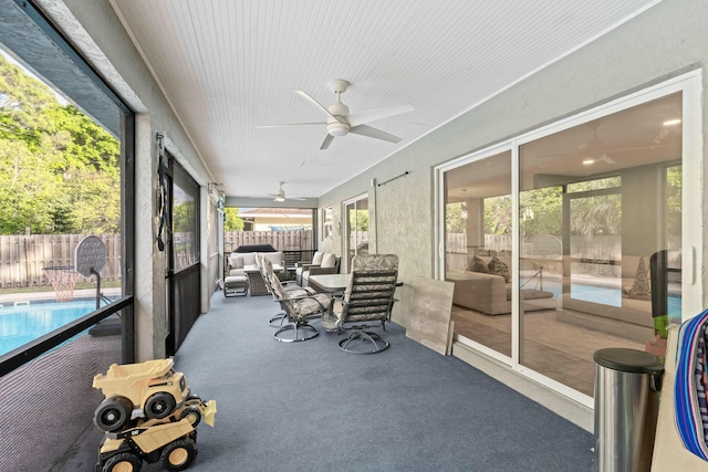 sunroom with a wealth of natural light and ceiling fan