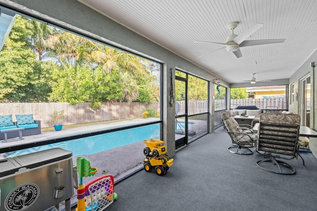 sunroom / solarium featuring ceiling fan