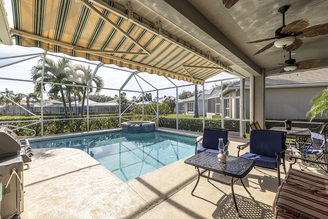 view of pool featuring a patio area, ceiling fan, and glass enclosure