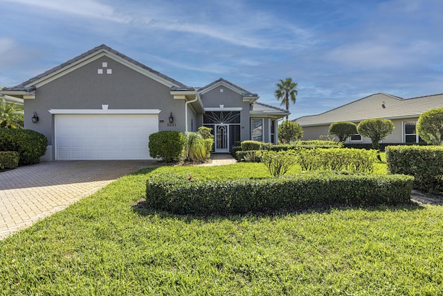 ranch-style home featuring a garage and a front lawn