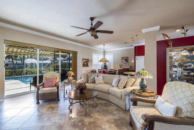 living room featuring tile patterned flooring, crown molding, ceiling fan, and a textured ceiling