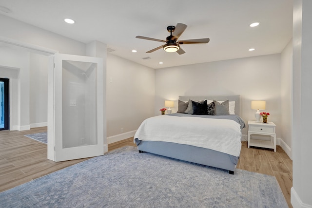 bedroom featuring light wood-type flooring and ceiling fan