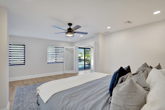 bedroom with ceiling fan, light hardwood / wood-style floors, and access to exterior