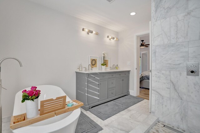 bathroom featuring vanity, a bathtub, and ceiling fan