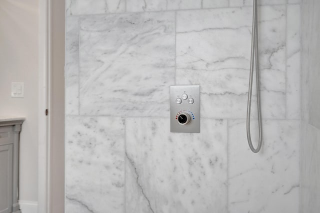 details featuring a tile shower and vanity