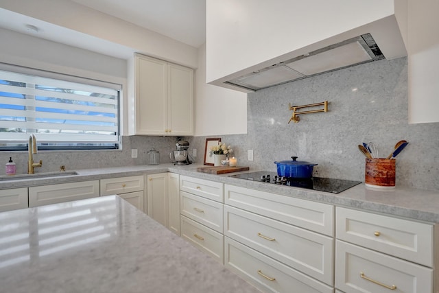 kitchen with white cabinetry, sink, backsplash, extractor fan, and black electric cooktop