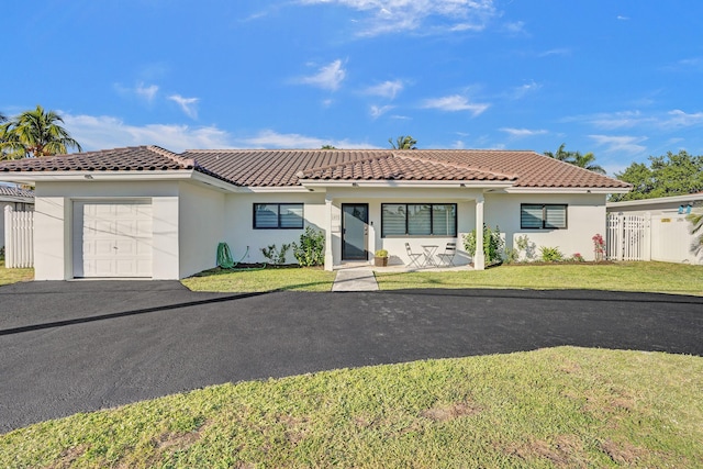 mediterranean / spanish-style house with a front lawn and a garage