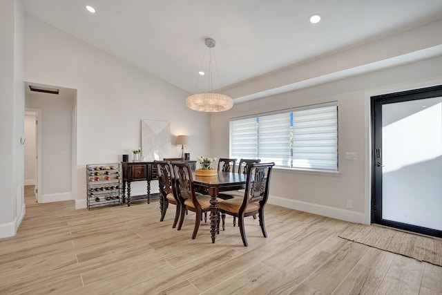 dining room with lofted ceiling and light wood-type flooring