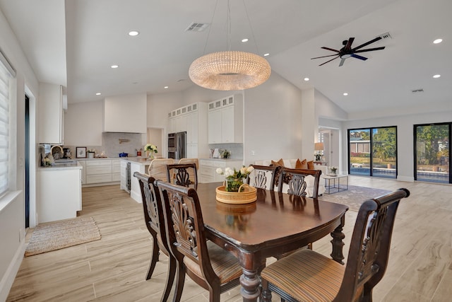 dining area with ceiling fan, sink, high vaulted ceiling, and light wood-type flooring