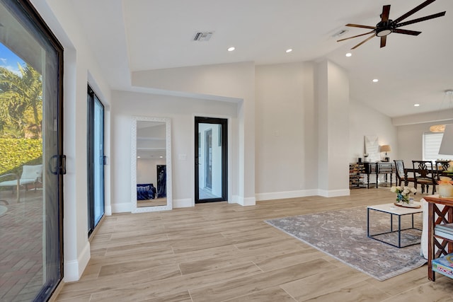 living room with light hardwood / wood-style flooring, plenty of natural light, lofted ceiling, and ceiling fan