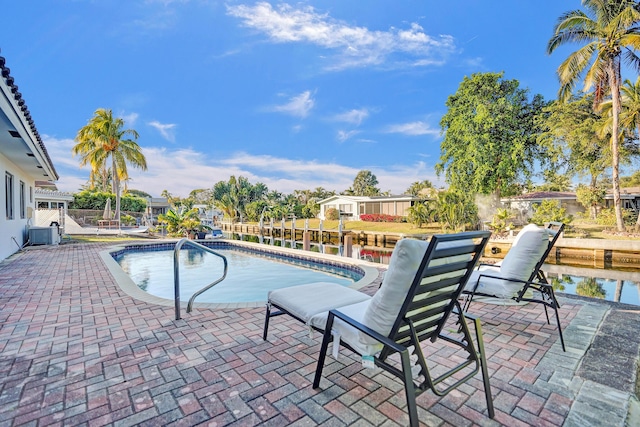 view of pool with a patio and cooling unit