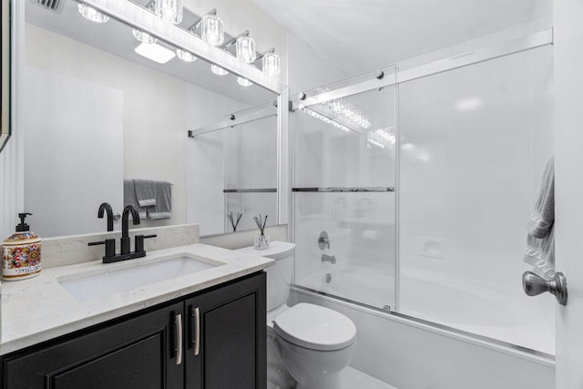 full bathroom with vanity, toilet, and bath / shower combo with glass door