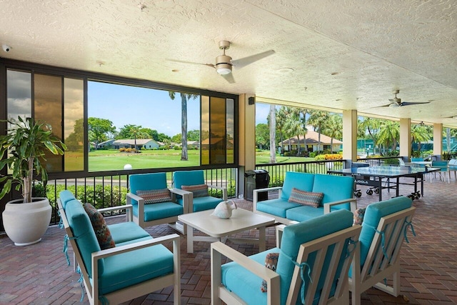 view of patio with an outdoor living space and ceiling fan