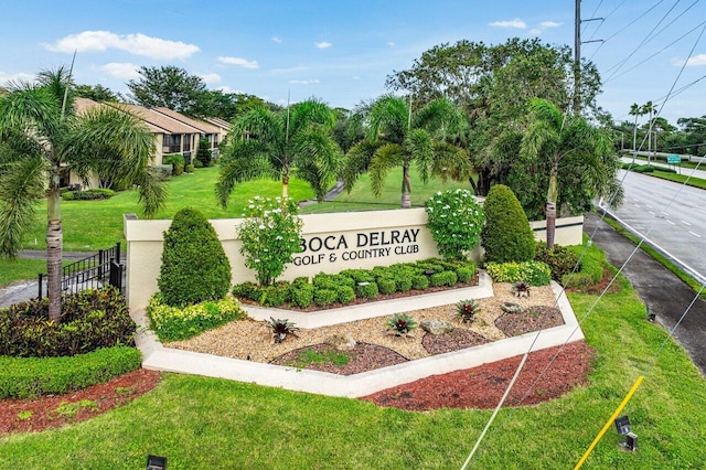 community / neighborhood sign featuring a lawn