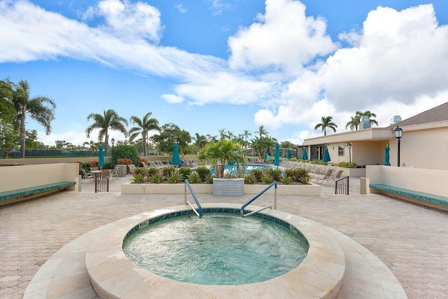 view of pool with a patio area and a community hot tub