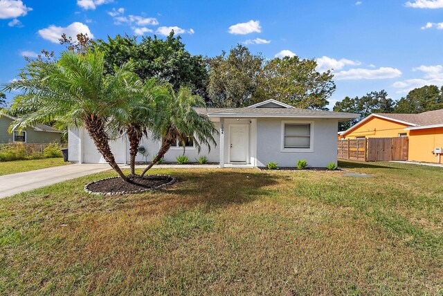 single story home featuring a front yard