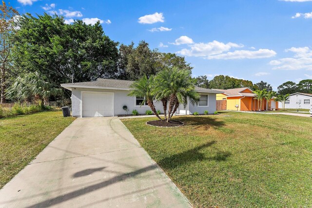 single story home with a front yard and a garage