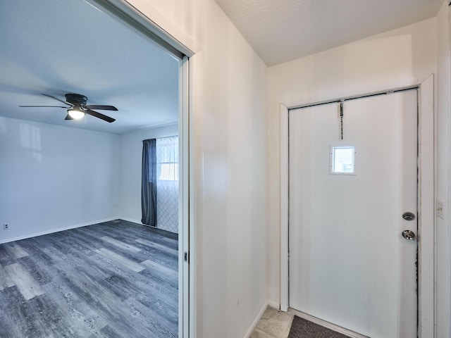 foyer with wood-type flooring, a textured ceiling, and ceiling fan