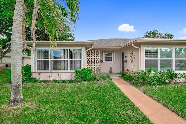 ranch-style home with a front lawn