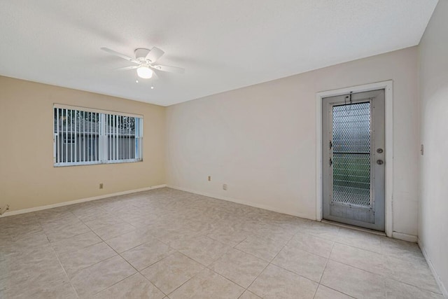 tiled empty room with ceiling fan