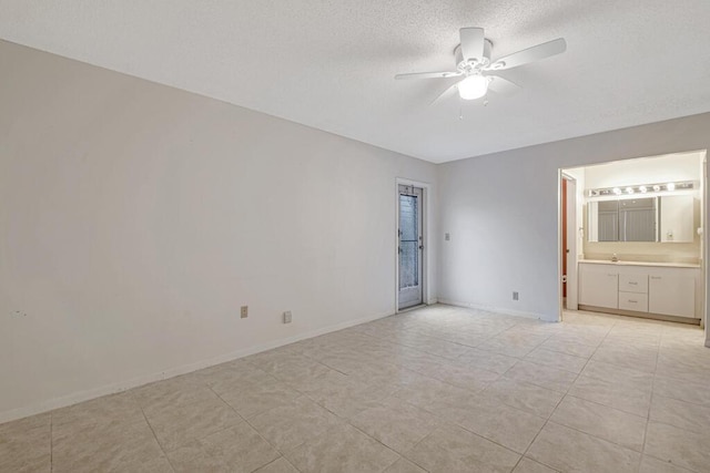 empty room with ceiling fan and light tile patterned floors