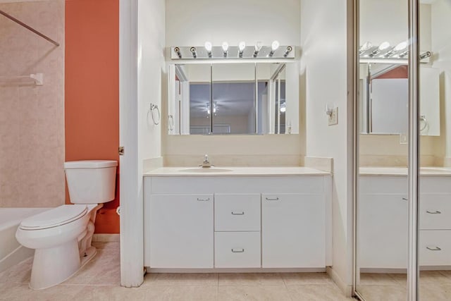 bathroom featuring tile patterned flooring, vanity, and toilet