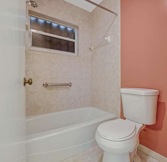 bathroom with tile patterned flooring, tiled shower / bath combo, and toilet