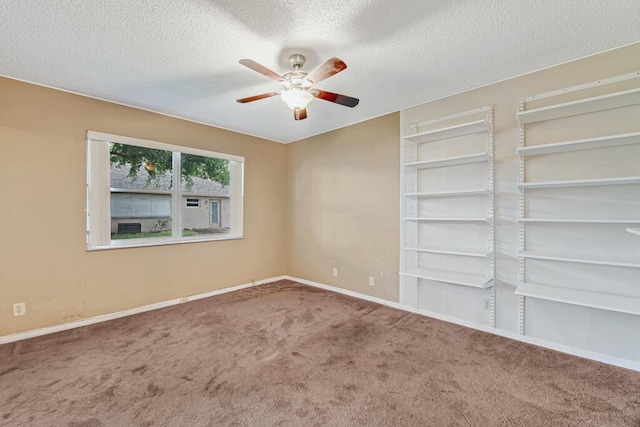 spare room featuring carpet flooring, a textured ceiling, and ceiling fan