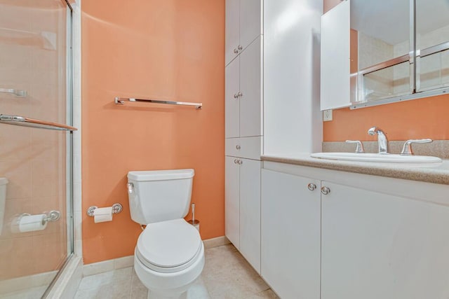 bathroom with an enclosed shower, vanity, toilet, and tile patterned floors