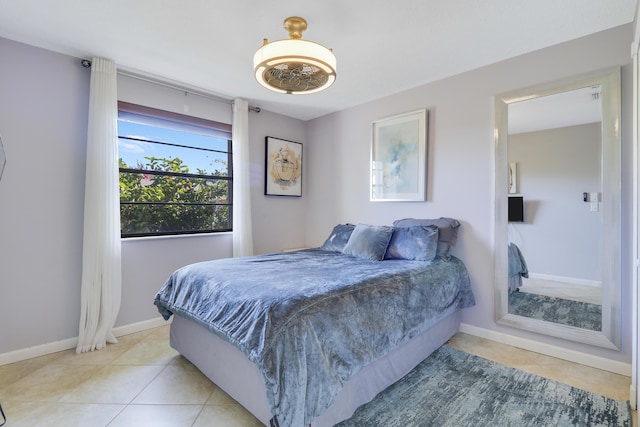 tiled bedroom featuring ceiling fan