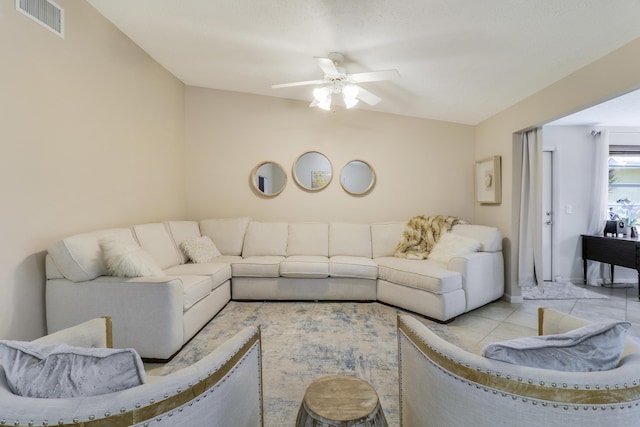 living room with ceiling fan and light tile patterned flooring