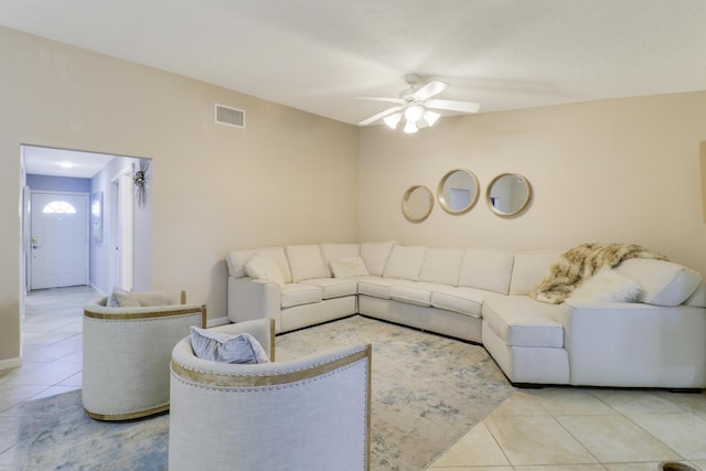 living room featuring light tile patterned floors and ceiling fan