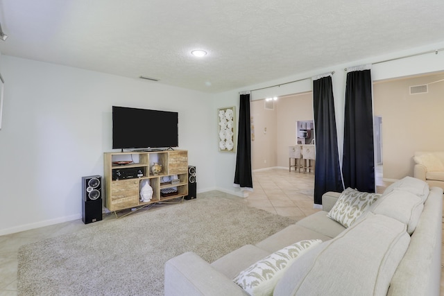 living room with light tile patterned flooring and a textured ceiling