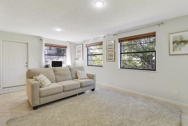 living room with light tile patterned floors and a textured ceiling