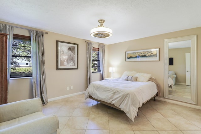 tiled bedroom featuring a textured ceiling